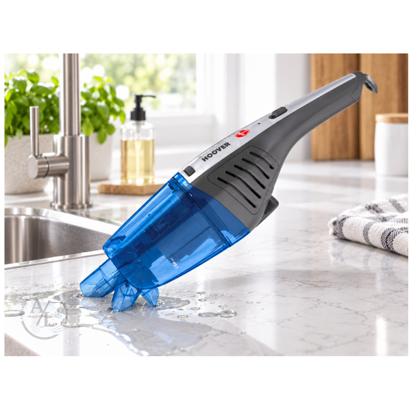 Hoover HJ72WDLB wet and dry handheld vacuum picking up spilled liquid on a kitchen counter